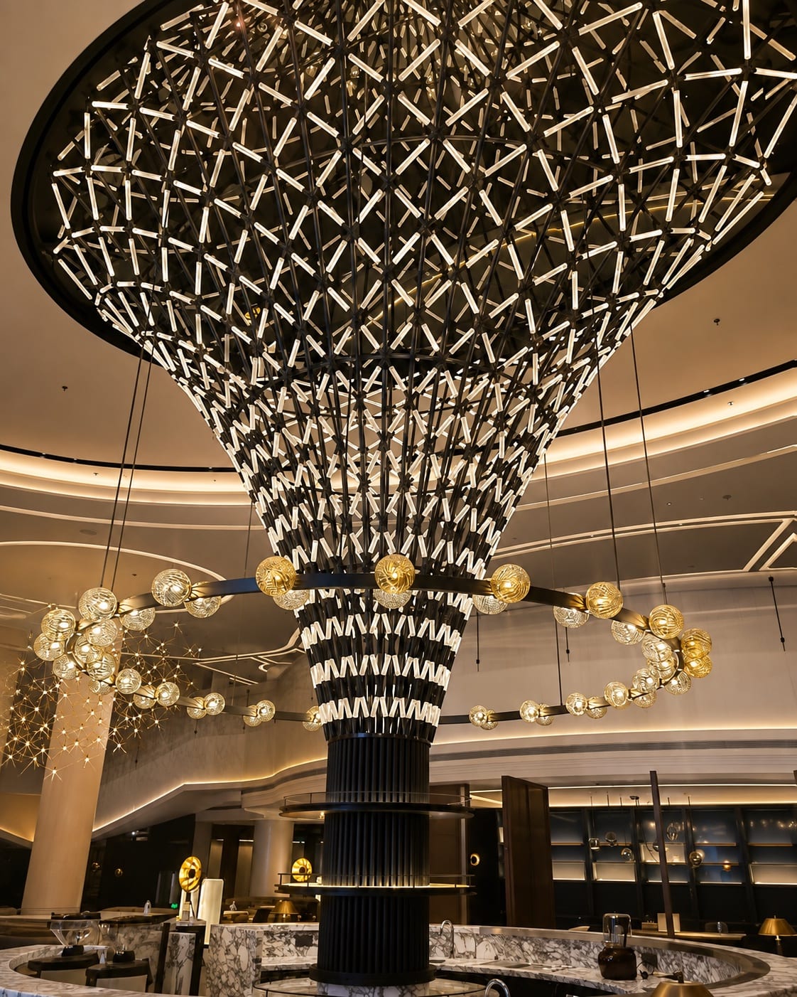 Large-scale bespoke decorative chandelier installed in a hospitality interior