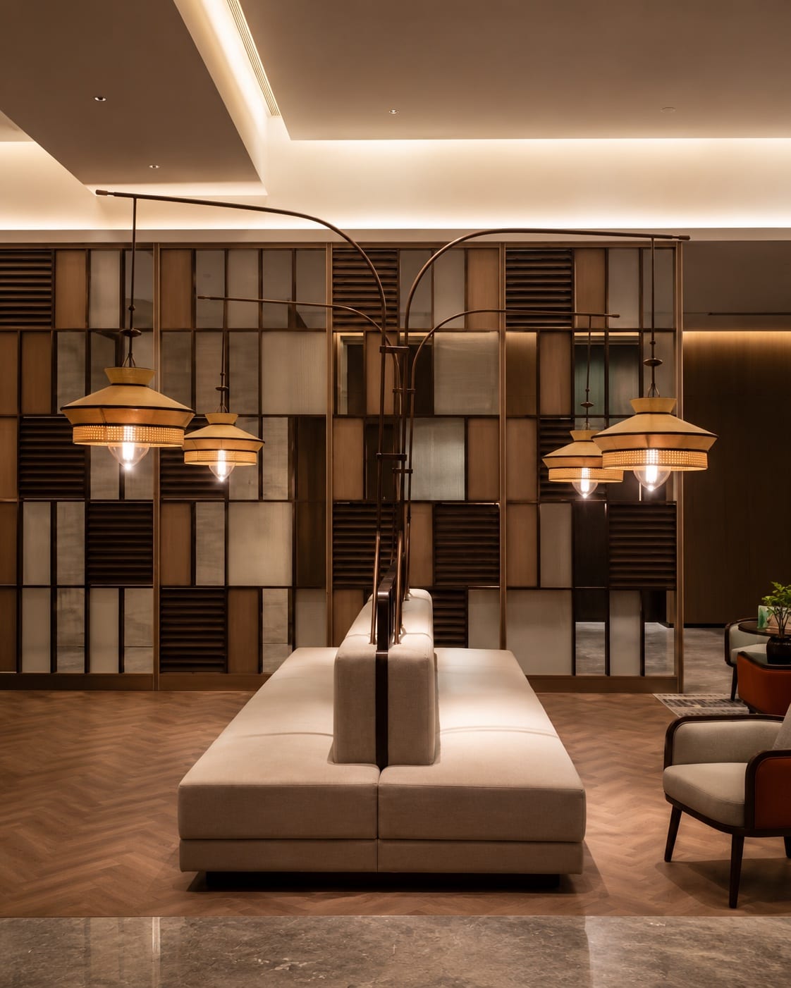 Warm-toned decorative pendants arranged above lounge seating