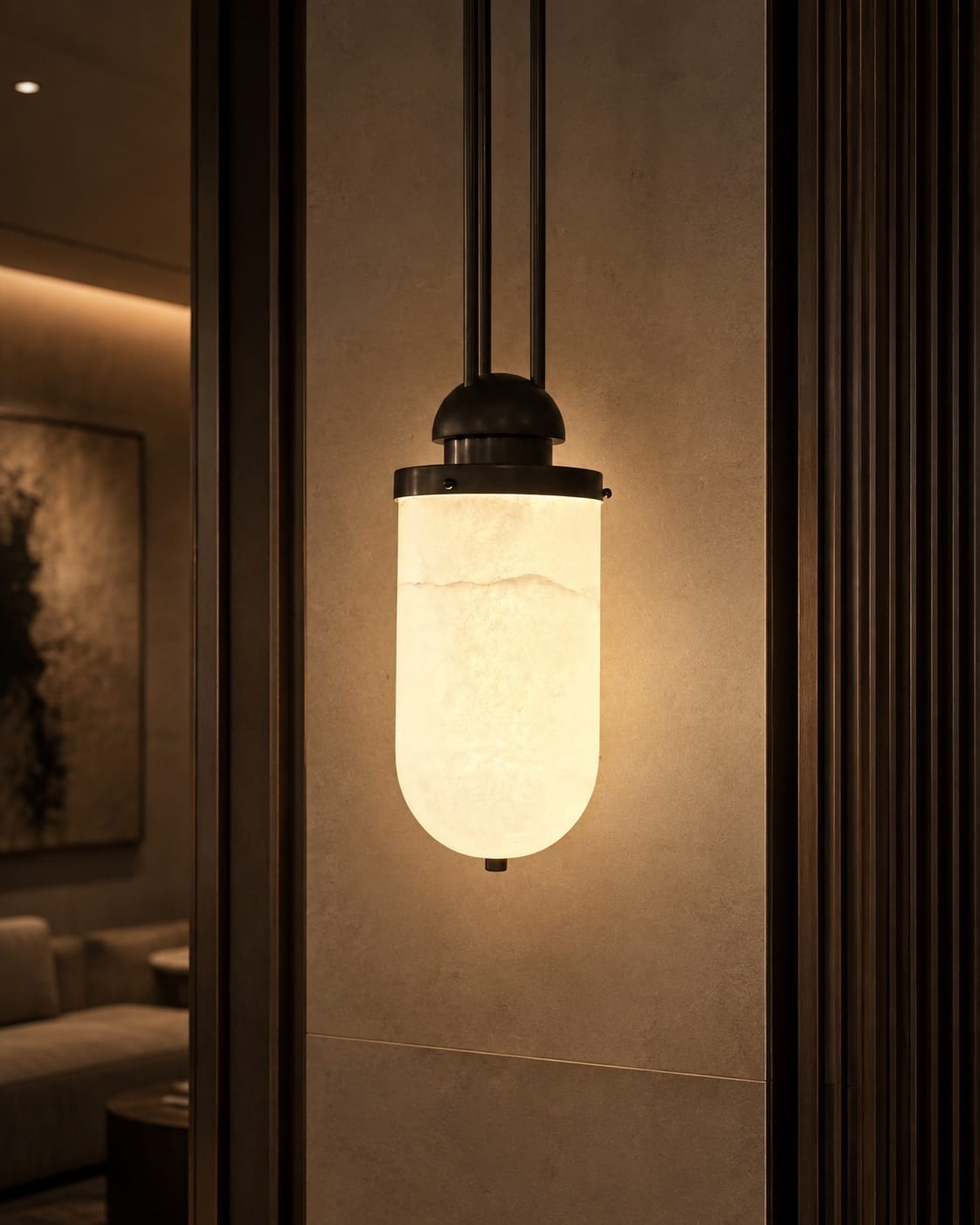 Cylindrical pendant light with a softly glowing translucent shade and dark metal connection