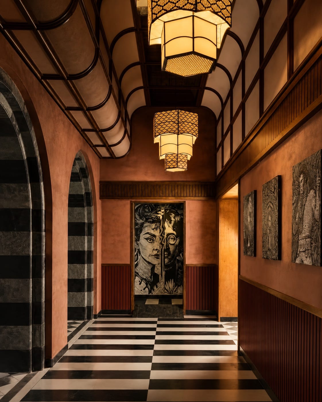 Decorative lanterns repeating through an arched hospitality corridor