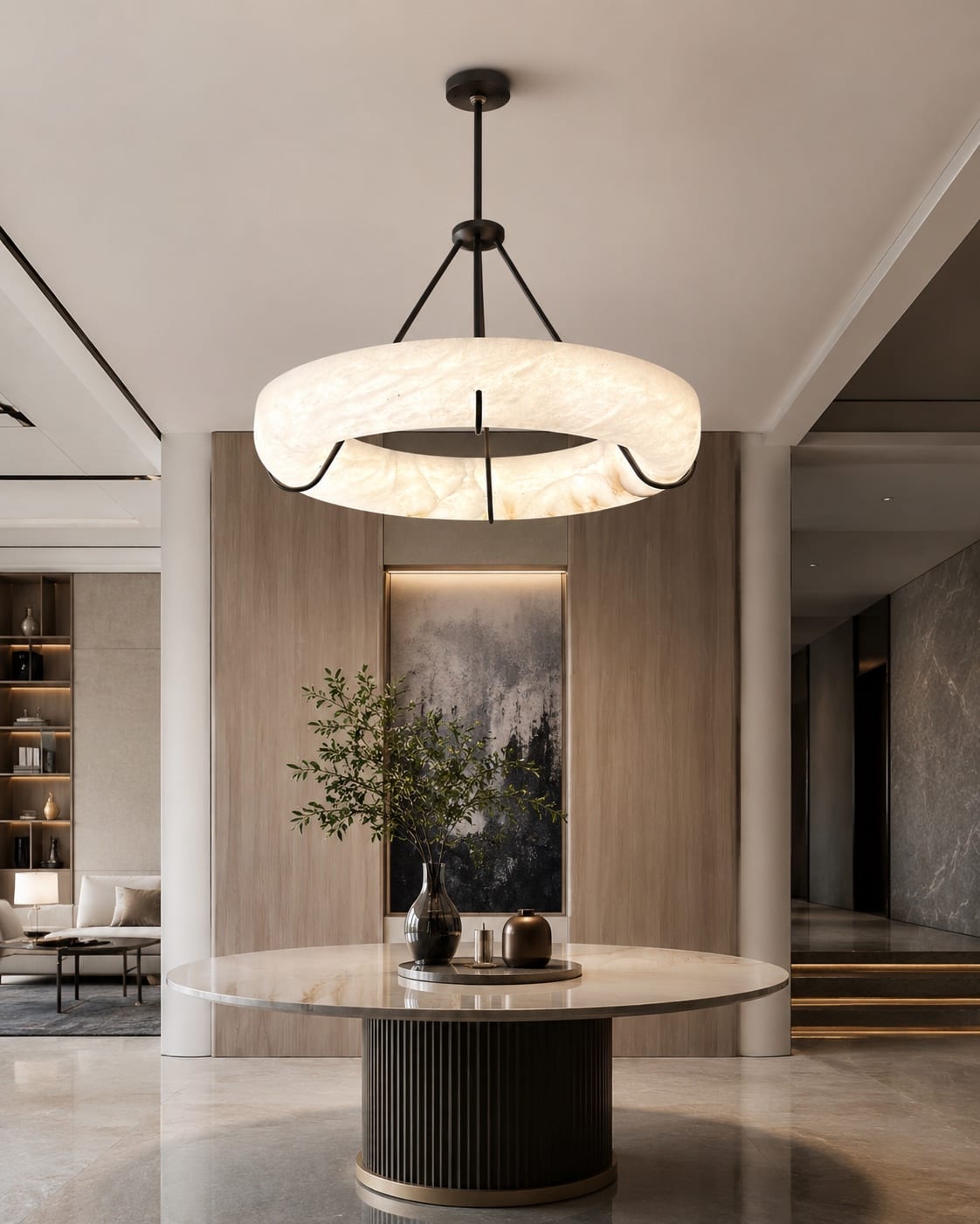 Illuminated alabaster ring pendant above a round table in a refined interior