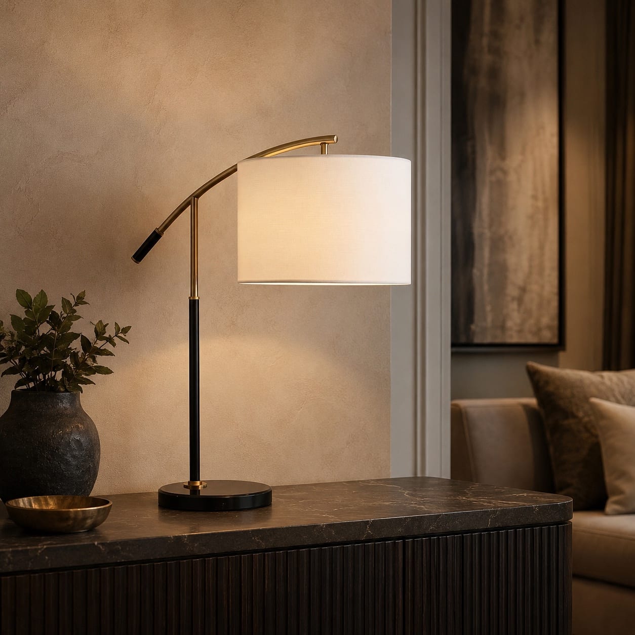 Custom black and brass table lamp with an arched reading arm and illuminated white drum shade