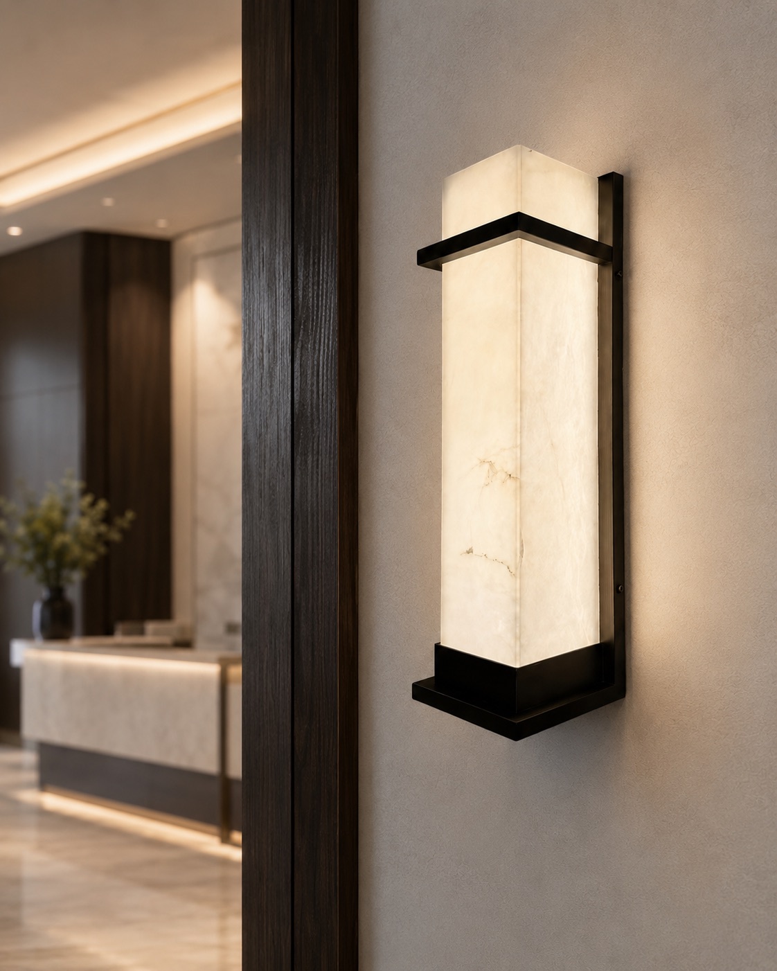Rectilinear custom alabaster wall light with a dark metal frame in a warm contemporary corridor